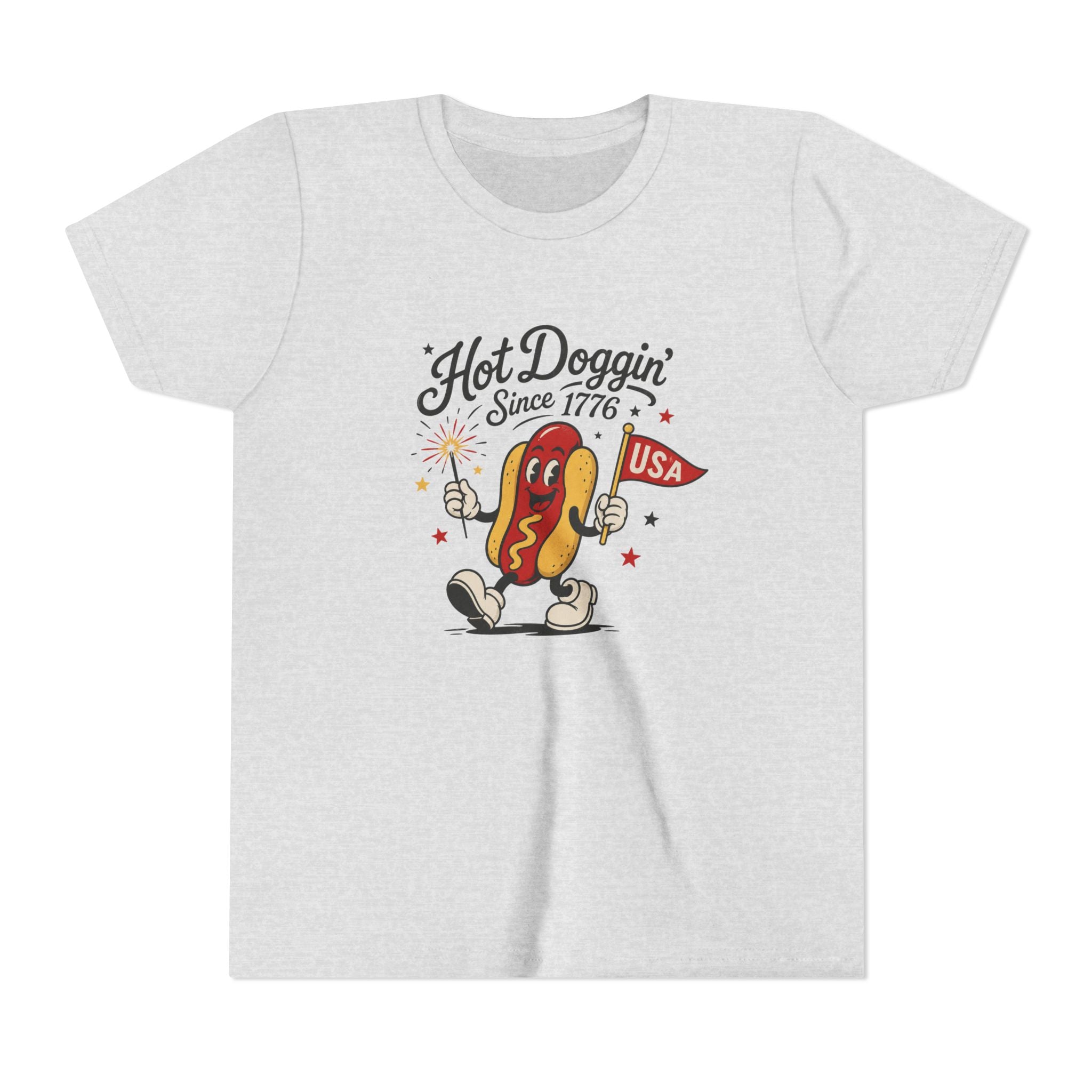 Hot Doggin Since 1776 Tee, Patriotic USA Hot Dog Shirt, Funny Summer Cartoon Graphic Top, Fourth of July Celebration Outfit Youth Short Sleeve Tee