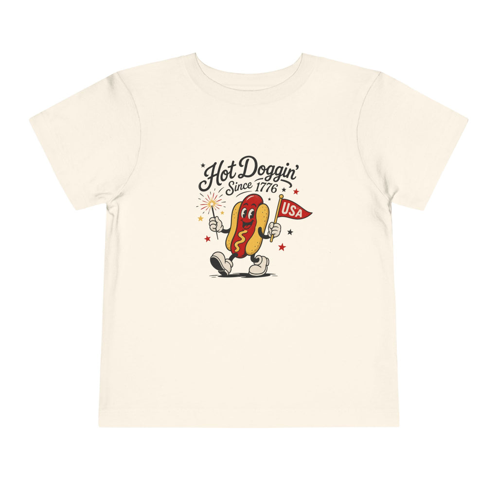 Hot Doggin Since 1776 Tee, Patriotic USA Hot Dog Shirt, Funny Summer Cartoon Graphic Top, Fourth of July Celebration Outfit Toddler Short Sleeve Tee