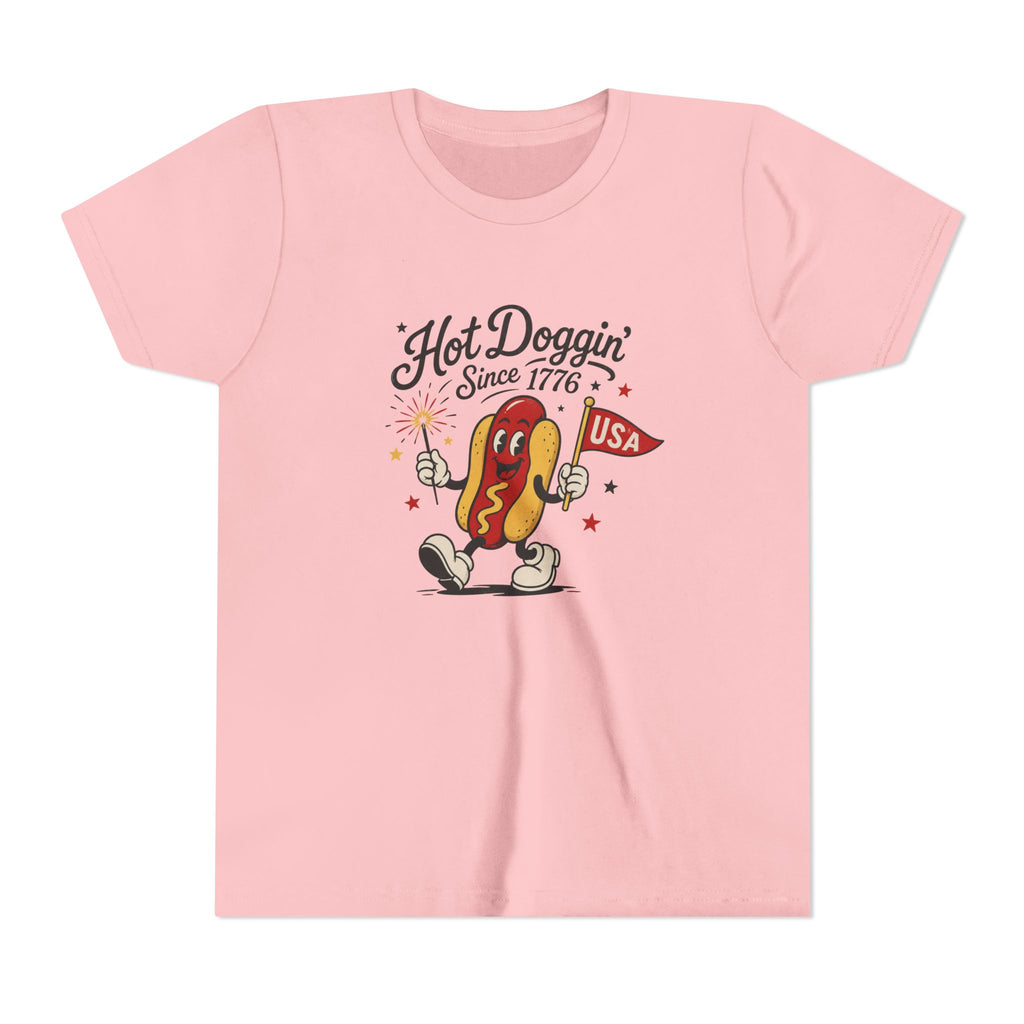 Hot Doggin Since 1776 Tee, Patriotic USA Hot Dog Shirt, Funny Summer Cartoon Graphic Top, Fourth of July Celebration Outfit Youth Short Sleeve Tee