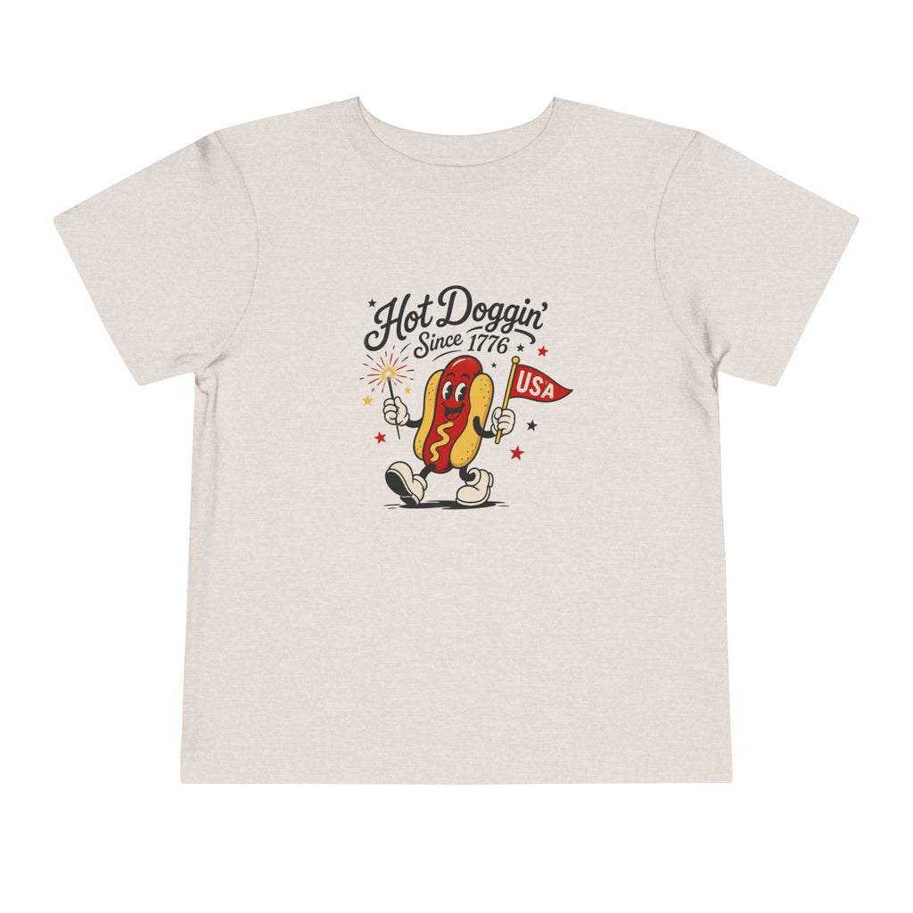 Hot Doggin Since 1776 Tee, Patriotic USA Hot Dog Shirt, Funny Summer Cartoon Graphic Top, Fourth of July Celebration Outfit Toddler Short Sleeve Tee