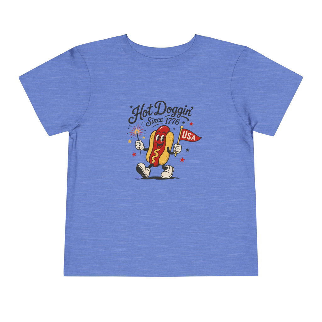 Hot Doggin Since 1776 Tee, Patriotic USA Hot Dog Shirt, Funny Summer Cartoon Graphic Top, Fourth of July Celebration Outfit Toddler Short Sleeve Tee