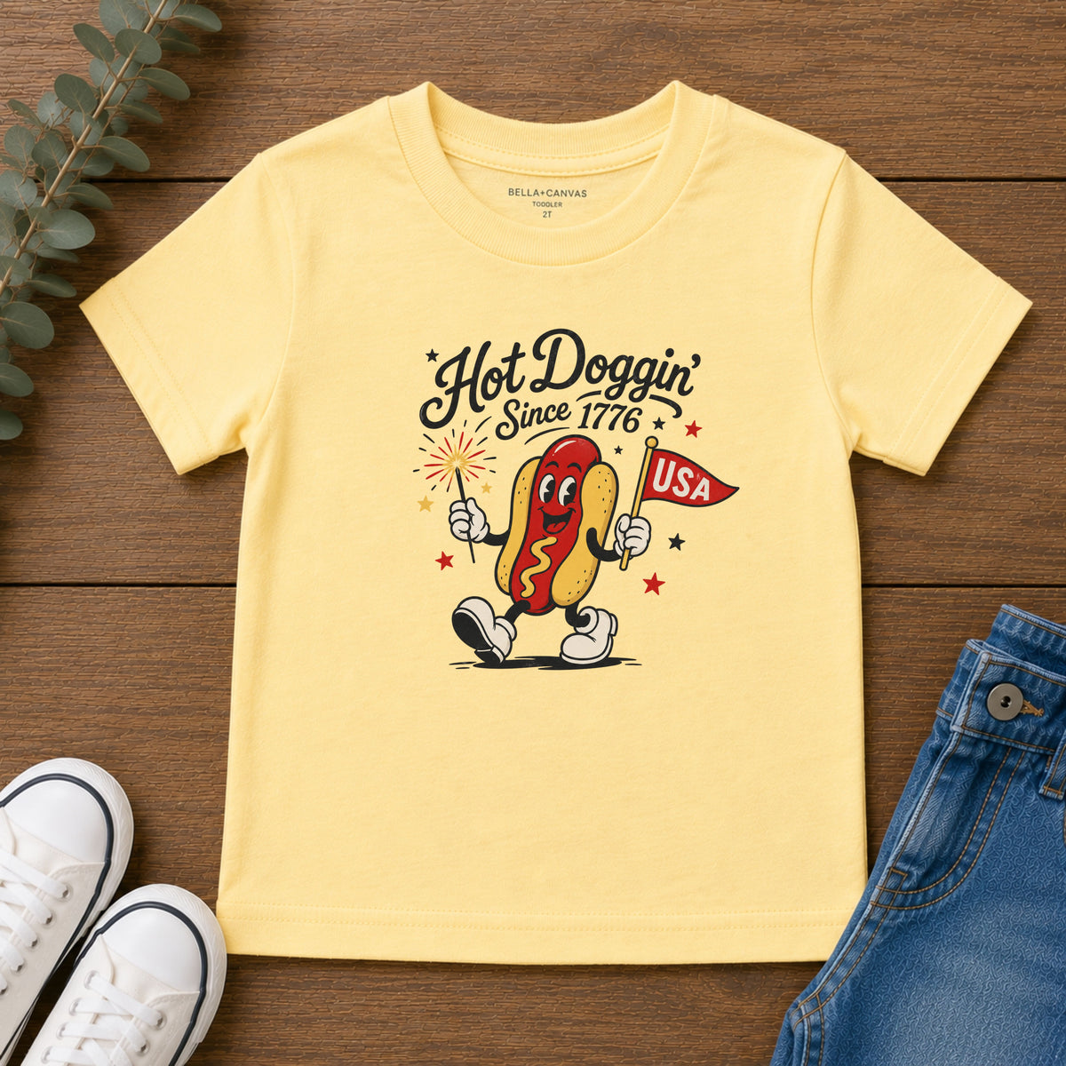 Hot Doggin Since 1776 Tee, Patriotic USA Hot Dog Shirt, Funny Summer Cartoon Graphic Top, Fourth of July Celebration Outfit Toddler Short Sleeve Tee